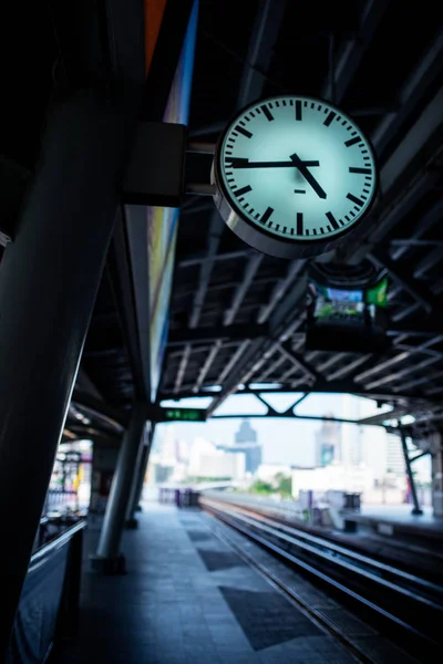 Clock at railway station toned in dark color — Stock Photo, Image