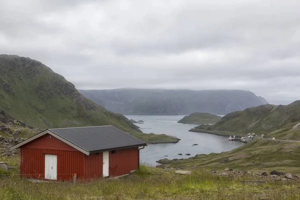 Traditional Norwegian house on the fjord in cloudy weather