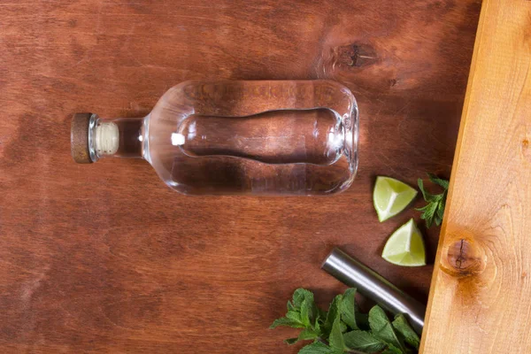 Bottle with strong alcohol on a wooden background