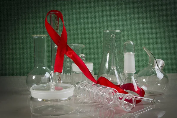 Laboratory Glassware Red Ribbon Green Background — Stock Photo, Image