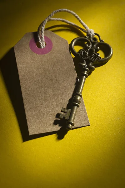 Old key with tag — Stock Photo, Image