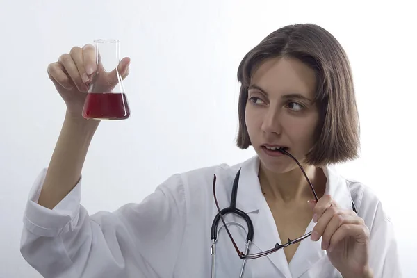 Doctor woman with stethoscope and flask — Stock Photo, Image