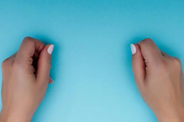 Female hands gestures on a blue background