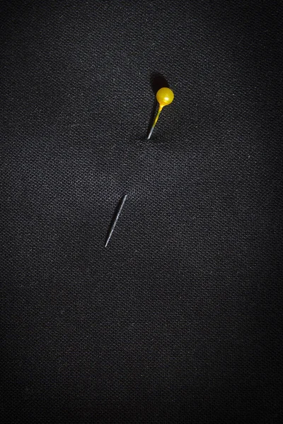 Pin Yellow Head Black Fabric — Stock Photo, Image