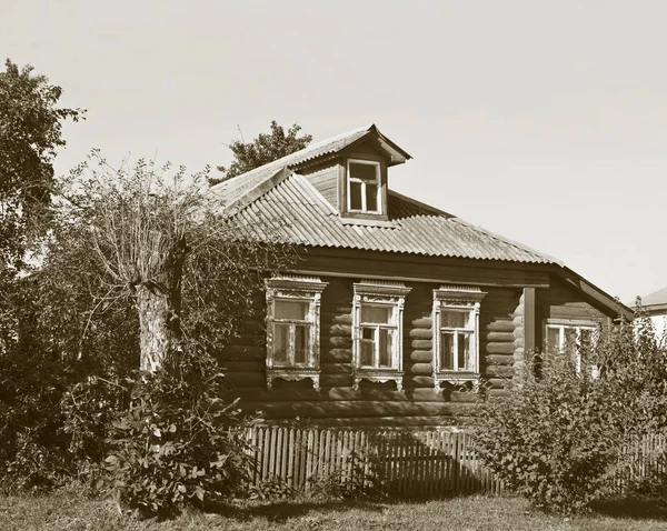 Old country log house with small dooryard in Vladimir region, Russia. Monochrome style.