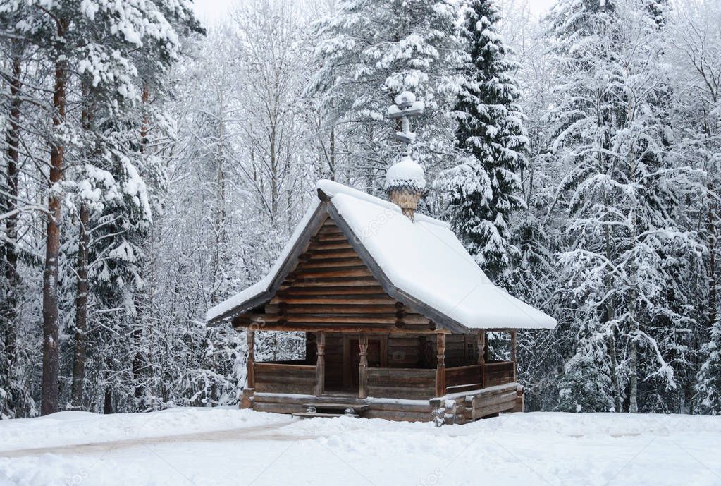 Old Russian wooden Chapel of Ilya the Prophet (18th century) in the northern open air museum Malye Korely near Arkhanglesk, Russia. Winter time.