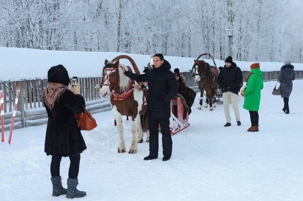 People with horses in winter time
