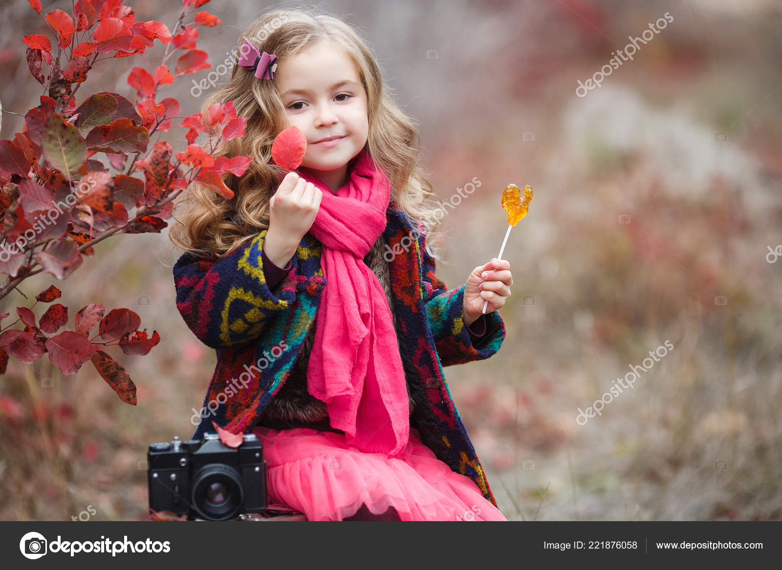 Pretty kid girl 4-5 year old wearing stylish autumn clothes in park.  Looking at camera. Fall season. Childhood. Stock Photo