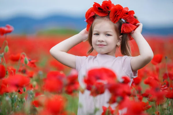 Little Girl Red Wreath Fresh Flowers Walking Poppy Field Sunny — Stock Photo, Image