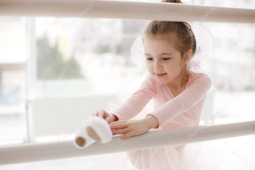 Little cute girl in class in ballet studio.Little ballerina girl in a pink tutu. Adorable child dancing classical ballet in a white studio. Children dance. Kids performing. Young gifted dancer in a class. Preschool kid taking art lessons