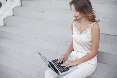 Eğitim kavramı-erkek öğrenci veya genç kadın beyaz görünüm laptop ya da bilgisayar araştırma bilgi tarafından ödev yapıyorsun. Güneşli bir gün açık havada bir laptop yaz aylarında şehirde güzel bir genç bayan portresi