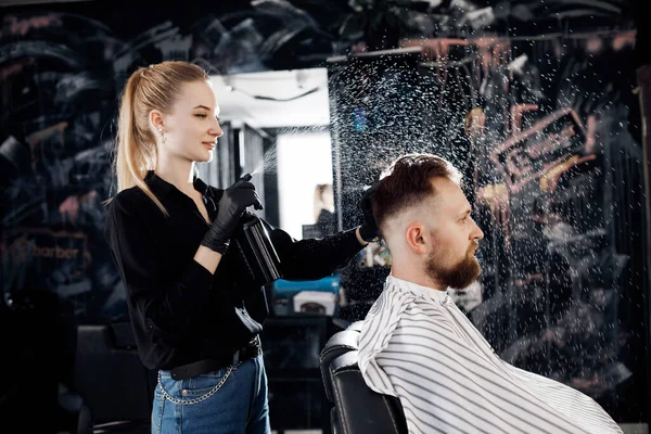 Retrato de um homem na Barbearia, barbear e cortar por barbeiro menina — Fotografia de Stock