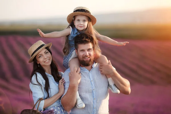 Happy family in laveder field. mother, father and child in sunset light in blooming lavender — Stock Photo, Image