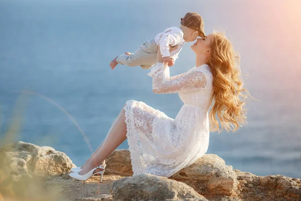 Hermosa mujer bonita con bebé niño al atardecer al aire libre. madre con hijo — Foto de Stock