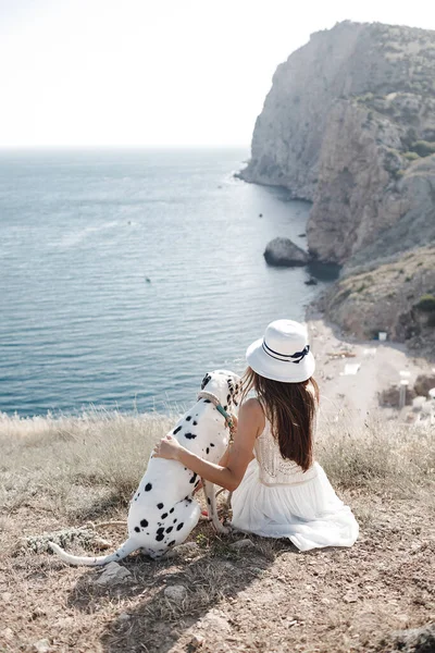 Kumsalda, arkada dalmaçyalı köpeği olan mutlu bir kadın. — Stok fotoğraf