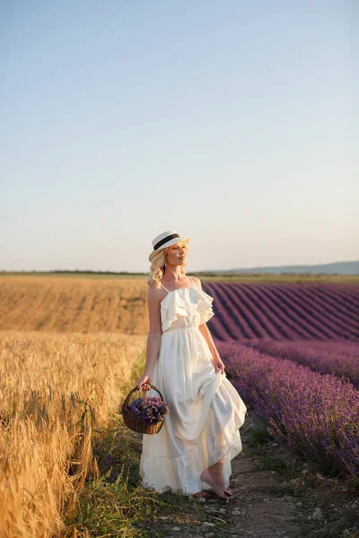 Happy young blonde woman in dress having fun in lavender blooming field in summer day — Stock Photo, Image