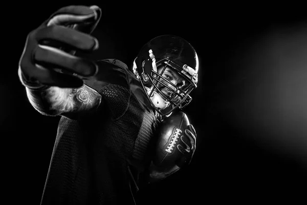 Sport concept. American football sportsman player on black background. Sport concept. — Stock Photo, Image