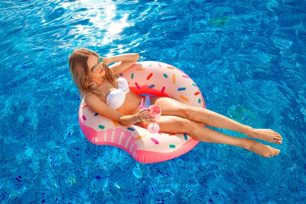 Summer Vacation. Woman in bikini on the inflatable donut mattress in the SPA swimming pool. Travel to the sea rest concept. — Stock Photo, Image