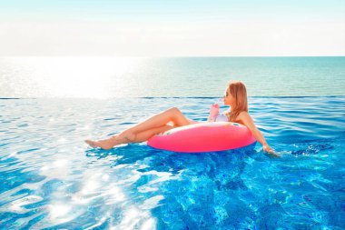 Yaz tatili. Bikini Spa yüzme havuzunda şişme çörek şişme kadın.