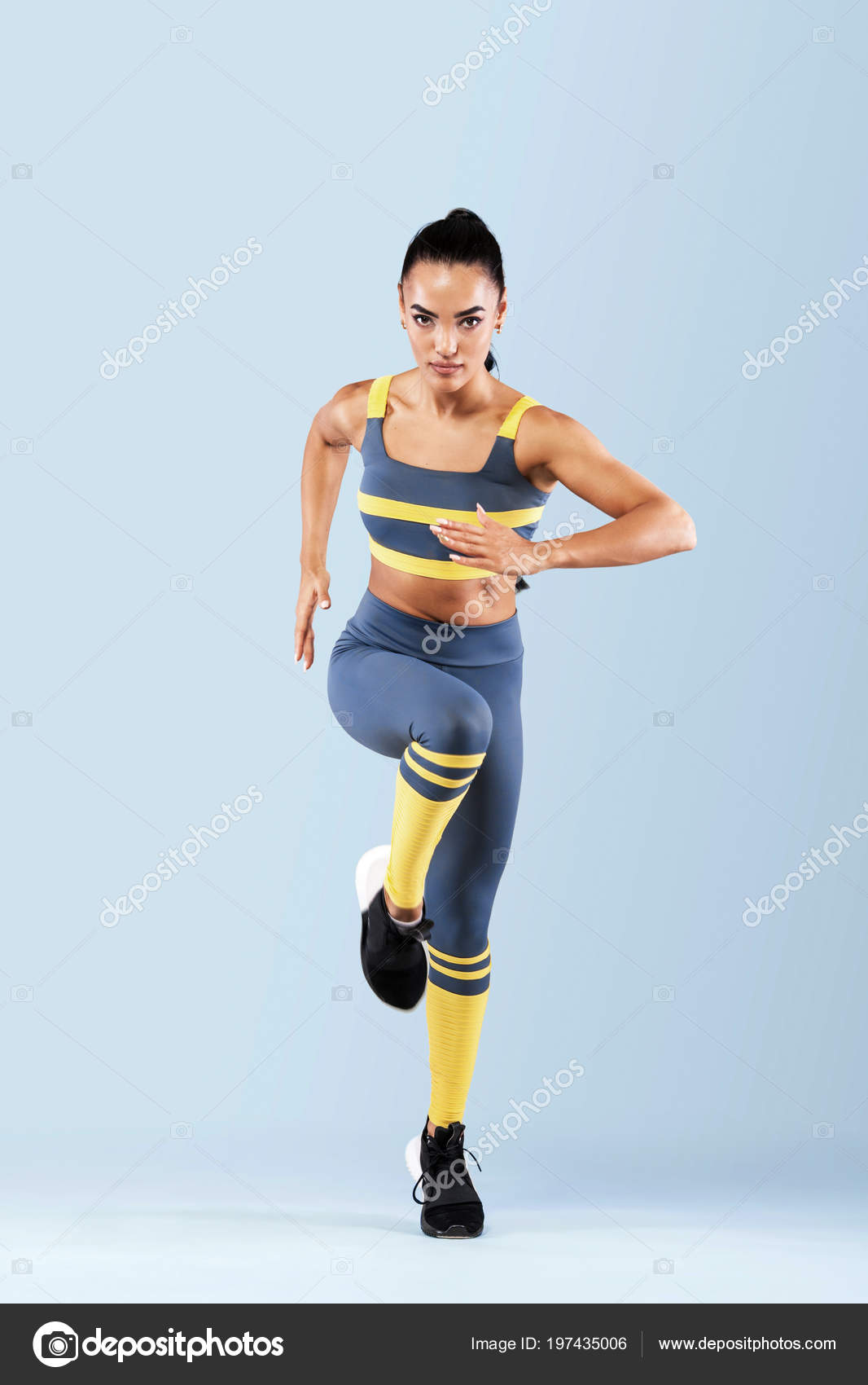 A strong athletic, women sprinter, running wearing in the