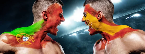 Portugal vs Spain. Two soccer or football fans with flags face to face on stadium.