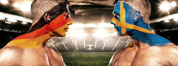 Deutschland vs Sverige. Two soccer or football fans with flags face to face on stadium. — Stock Photo, Image