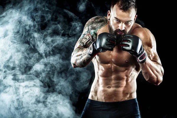 Street fighter fighting in boxing cage. Background with lights and smoke. Action shot with copy space.