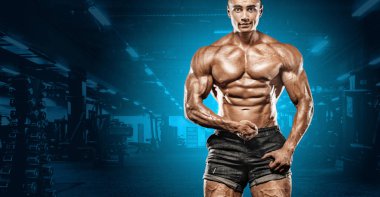 Spor salonu zemin üzerinde kas pompalama acımasız güçlü kas vücut geliştirmeci atletik adam. Egzersiz vücut geliştirme kavramı. Spor beslenme reklamlar için kopya alanı.