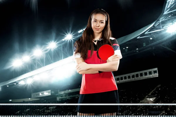 Young pretty sporty girl player table tennis on background with lights.. — Stock Photo, Image