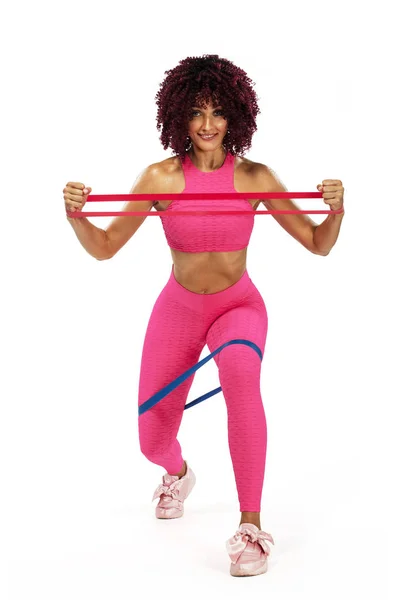 Muscular young fit sports woman athlete in pink sportswear with bands or expander in gym. Copy space for fitness nutrition ads. — Stock Photo, Image