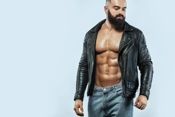 Close-up portrait of a brutal bearded man topless in a leather jacket — Stock Photo, Image