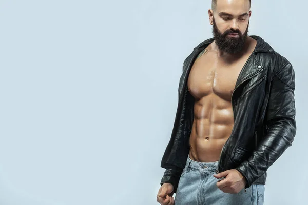 Close-up portrait of a brutal bearded man topless in a leather jacket — Stock Photo, Image