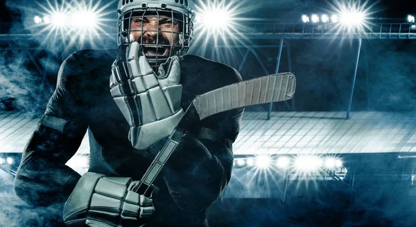 Jugador de hockey sobre hielo en el casco y guantes en el estadio con palo . —  Fotos de Stock