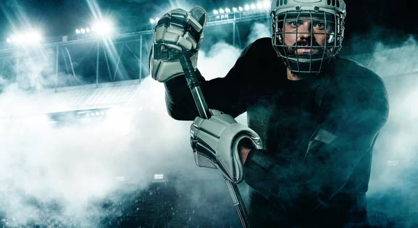 Ice Hockey player in the helmet and gloves on stadium with stick. — Stock Photo, Image