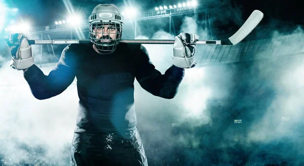 Хоккеист в шлеме и перчатки на стадионе с клюшкой . — стоковое фото
