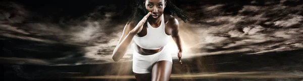 Strong athletic woman sprinter, running on dark background wearing in sportswear. Fitness and sport motivation. Runner concept. — Stock Photo, Image