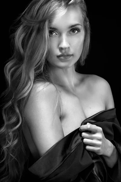 Black and white photo. Portrait of beautiful blonde woman on black background. — Stock Photo, Image