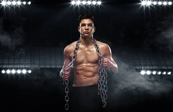 Teenager men sportsmen. Portrait of a brutal boy with chains. Athlete bodybuilder on black background. — Stock Photo, Image