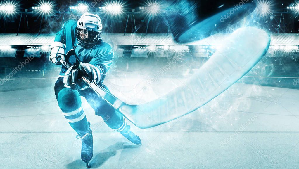 Ice Hockey player athlete in the helmet and gloves on stadium with stick. Action shot. Sport concept.