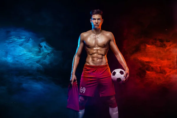 Teenager - soccer player. Boy in football sportswear after game with ball. Sport concept.