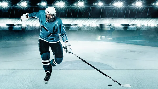 Ishockey spelare idrottsman i hjälmen och handskar på stadion med pinne. Åtgärdsskott. Idrottsbegreppet. — Stockfoto