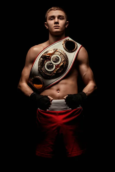 Sportsman, man boxer fighting in gloves with a championship belt. Isolated on black background with smoke. Copy Space. — Stock Photo, Image