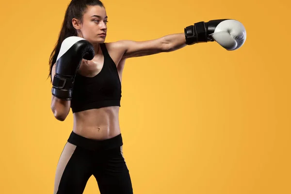 Sportivo, pugile donna che lotta con i guanti. su sfondo giallo. Boxe e fitness concept . — Foto Stock