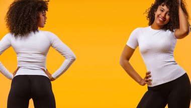 Siyah tenli ve kıvırcık saçlı güçlü atletik kadın, spor giyim giyen sarı arka plan üzerinde poz. Fitness ve spor motivasyonu. Katalog örneği.