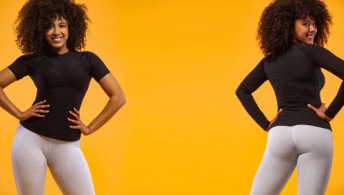 Siyah tenli ve kıvırcık saçlı güçlü atletik kadın, spor giyim giyen sarı arka plan üzerinde poz. Fitness ve spor motivasyonu. Katalog örneği.