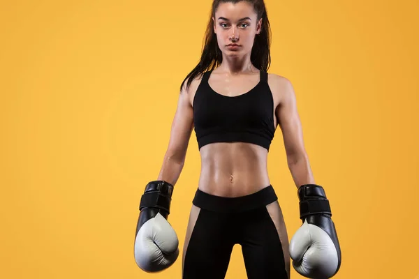 Sportivo, pugile donna che lotta con i guanti. su sfondo giallo. Boxe e fitness concept . — Foto Stock