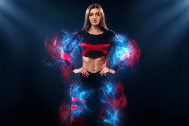 Güçlü atletik kadın spor içinde giyen siyah arka plan üzerine poz. Enerji fitness ve spor motivasyon. Kopya alanı.