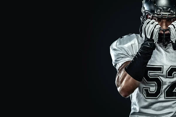 American football sportsman player in helmet isolated on black background. Sport and motivation wallpaper. — Stock Photo, Image