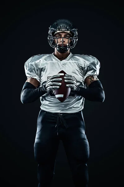 Desportista de futebol americano jogador de capacete em fundo preto. Desporto e motivação. Desportos de equipa . — Fotografia de Stock