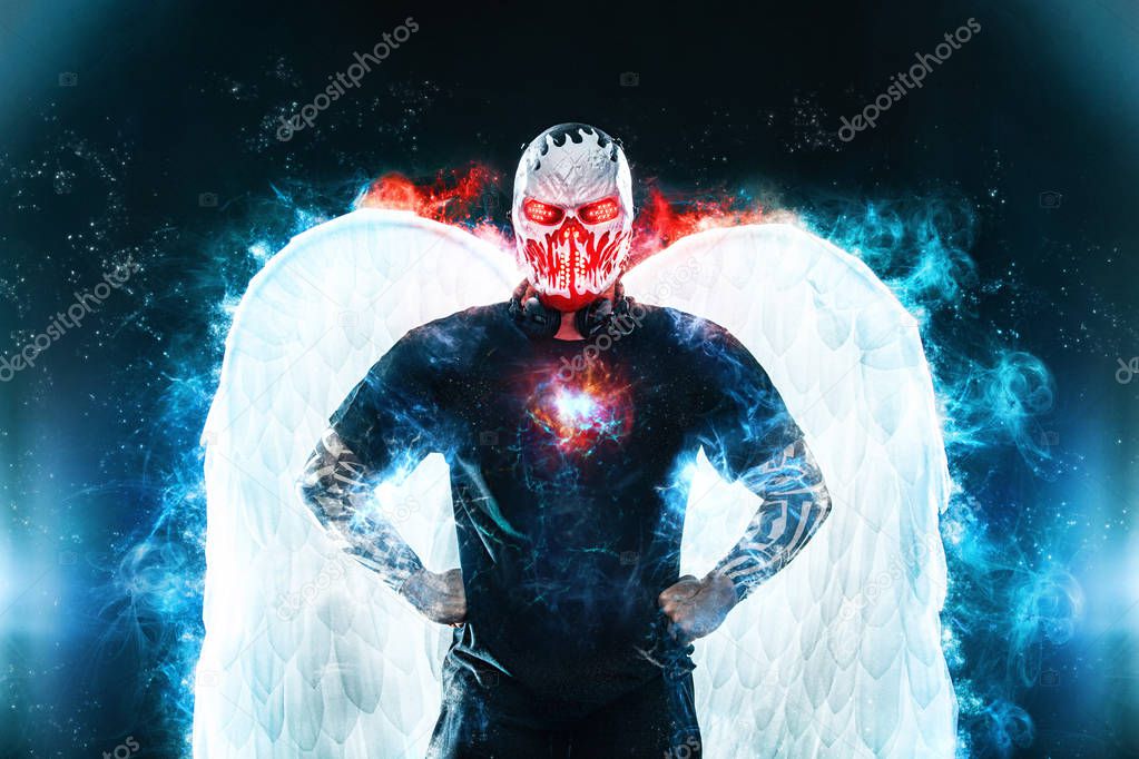 Mysterious man in black wear and skull mask with white wings. Fantasy book or computer game cover concept on halloween party.